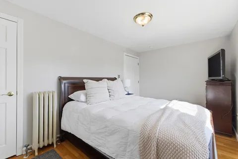 a bedroom with a bed and a tv