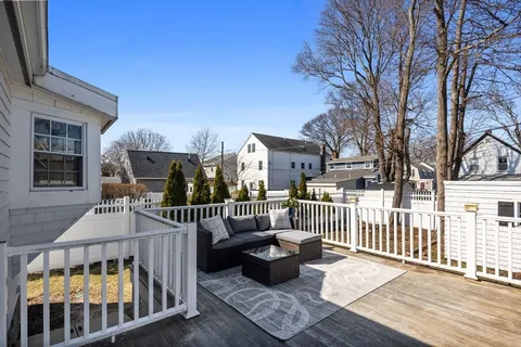 a view of a deck with couches table and chairs