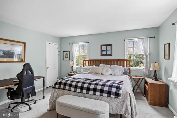 a bedroom with bed and a window