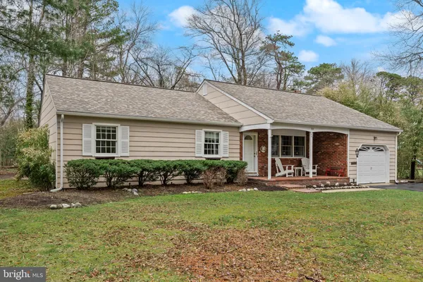 a front view of a house with a yard and patio