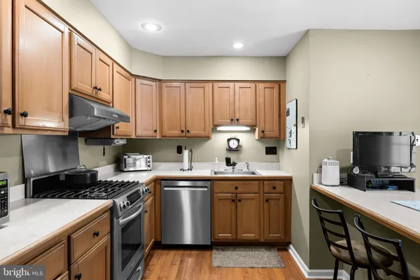 a kitchen with stainless steel appliances a refrigerator sink and cabinets