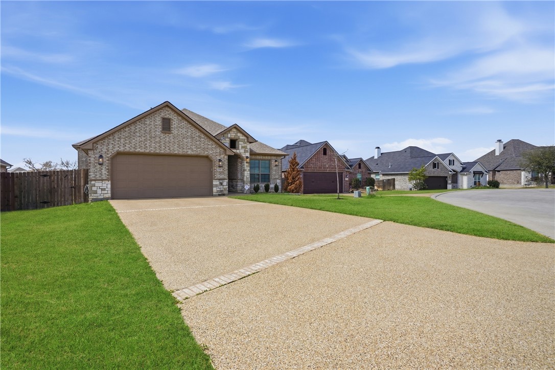 3516 Foxcroft Path Bryan, TX 77808 - Photo 2 of 38 a front view of a house with a yard and garage