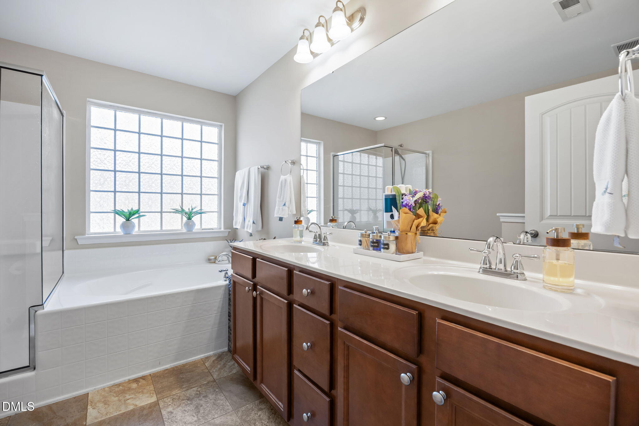 5049 Jelynn Street Raleigh, NC 27616 - Photo 15 of 33 a bathroom with a sink double vanity granite tub shower and a mirror