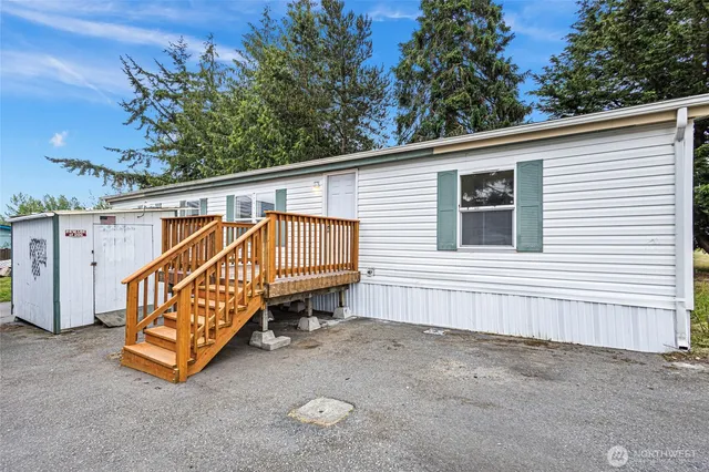 a view of a house with a bed and wooden fence