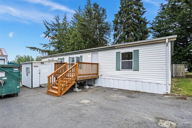 a view of a house with a bed and wooden fence