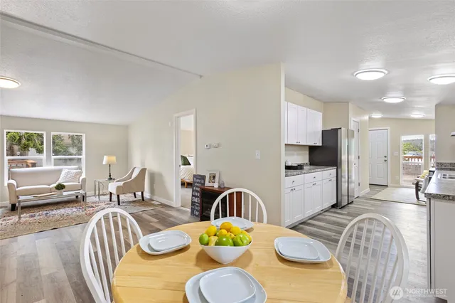 a living room with dining table furniture a dining table and chairs