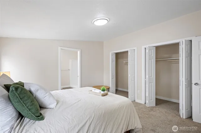 a bedroom with a bed and a mirror