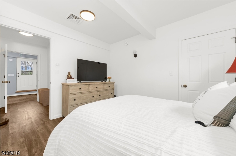 128 East Main Street Lebanon, NJ 08833 - Photo 16 of 36 a bedroom with a bed and a flat screen tv