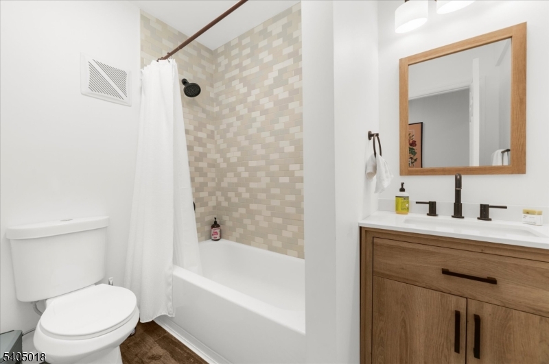 128 East Main Street Lebanon, NJ 08833 - Photo 17 of 36 a bathroom with a bathtub shower sink vanity mirror and toilet
