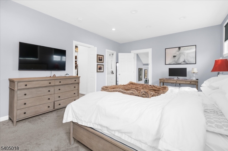 128 East Main Street Lebanon, NJ 08833 - Photo 19 of 36 a bedroom with a bed and a flat screen tv