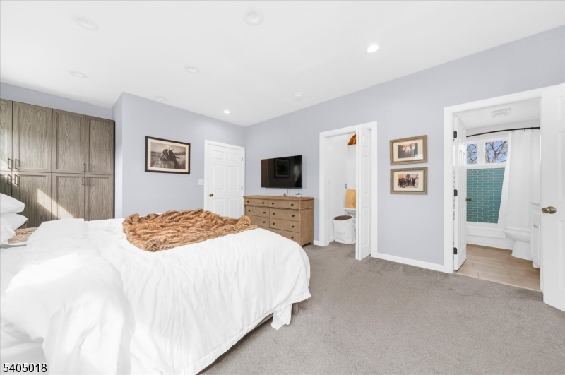 128 East Main Street Lebanon, NJ 08833 - Photo 20 of 36 a bedroom with a bed and a flat screen tv