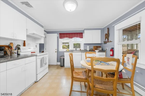 a large kitchen with a table and chairs in it