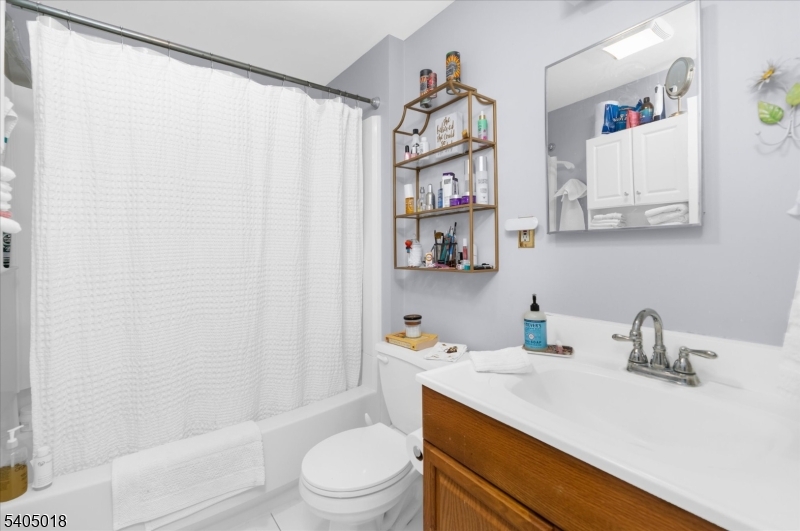 128 East Main Street Lebanon, NJ 08833 - Photo 30 of 36 a bathroom with a sink a toilet and shower curtain