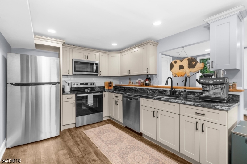 128 East Main Street Lebanon, NJ 08833 - Photo 6 of 36 a kitchen with granite countertop a refrigerator and a stove top oven