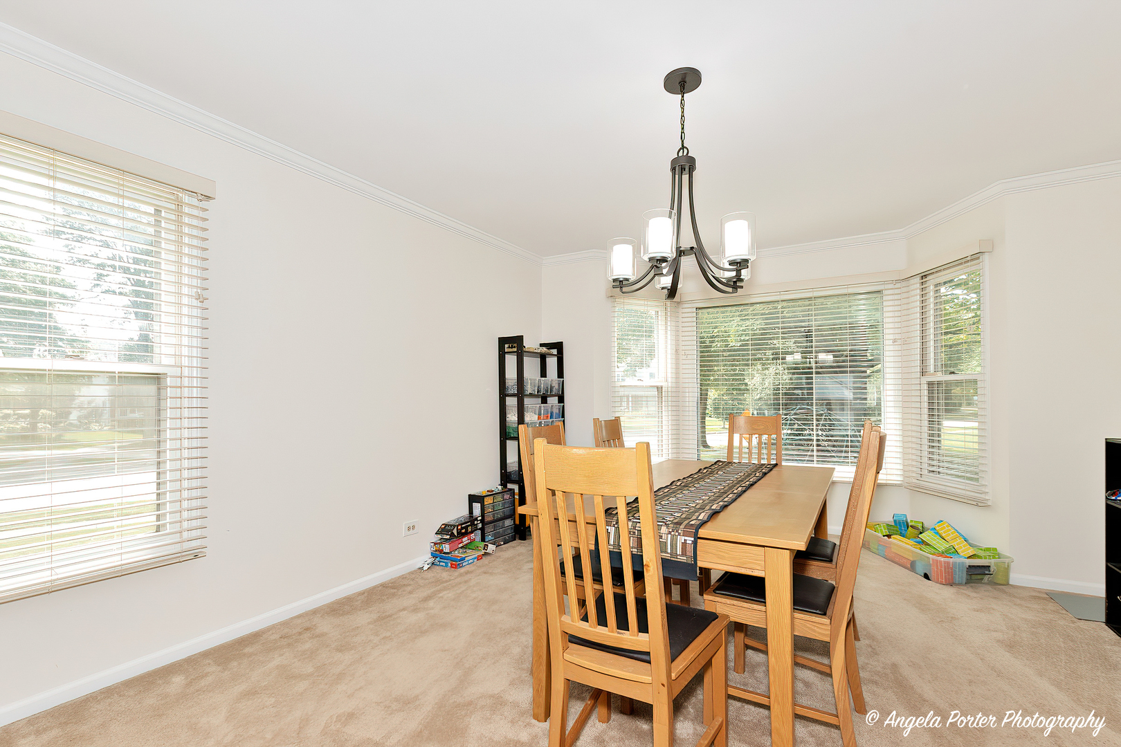 600 Raintree Road Buffalo Grove, IL 60089 - Photo 11 of 46 a dining room with furniture a chandelier and wooden floor