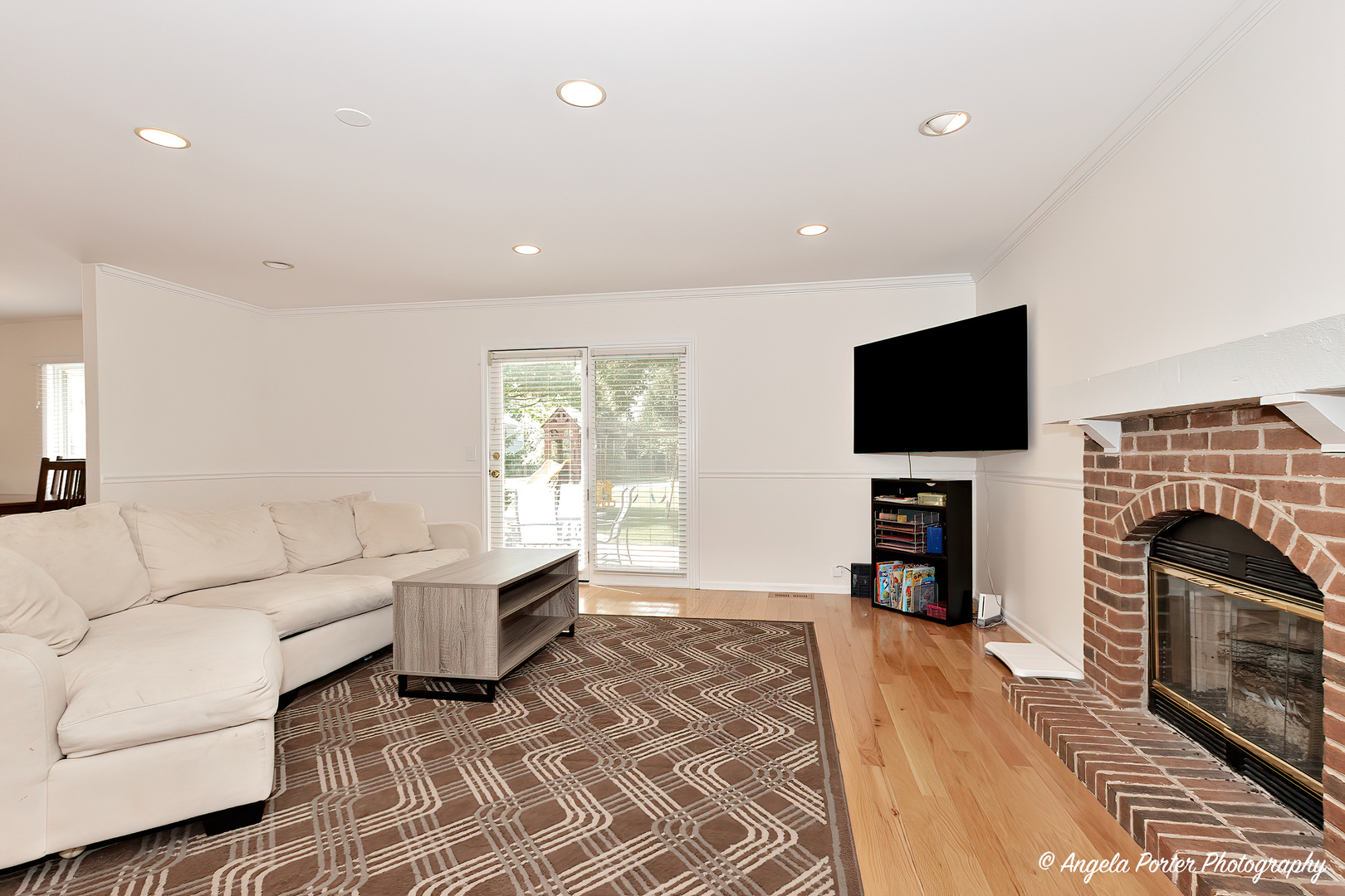 600 Raintree Road Buffalo Grove, IL 60089 - Photo 17 of 46 a living room with furniture a fireplace and a flat screen tv