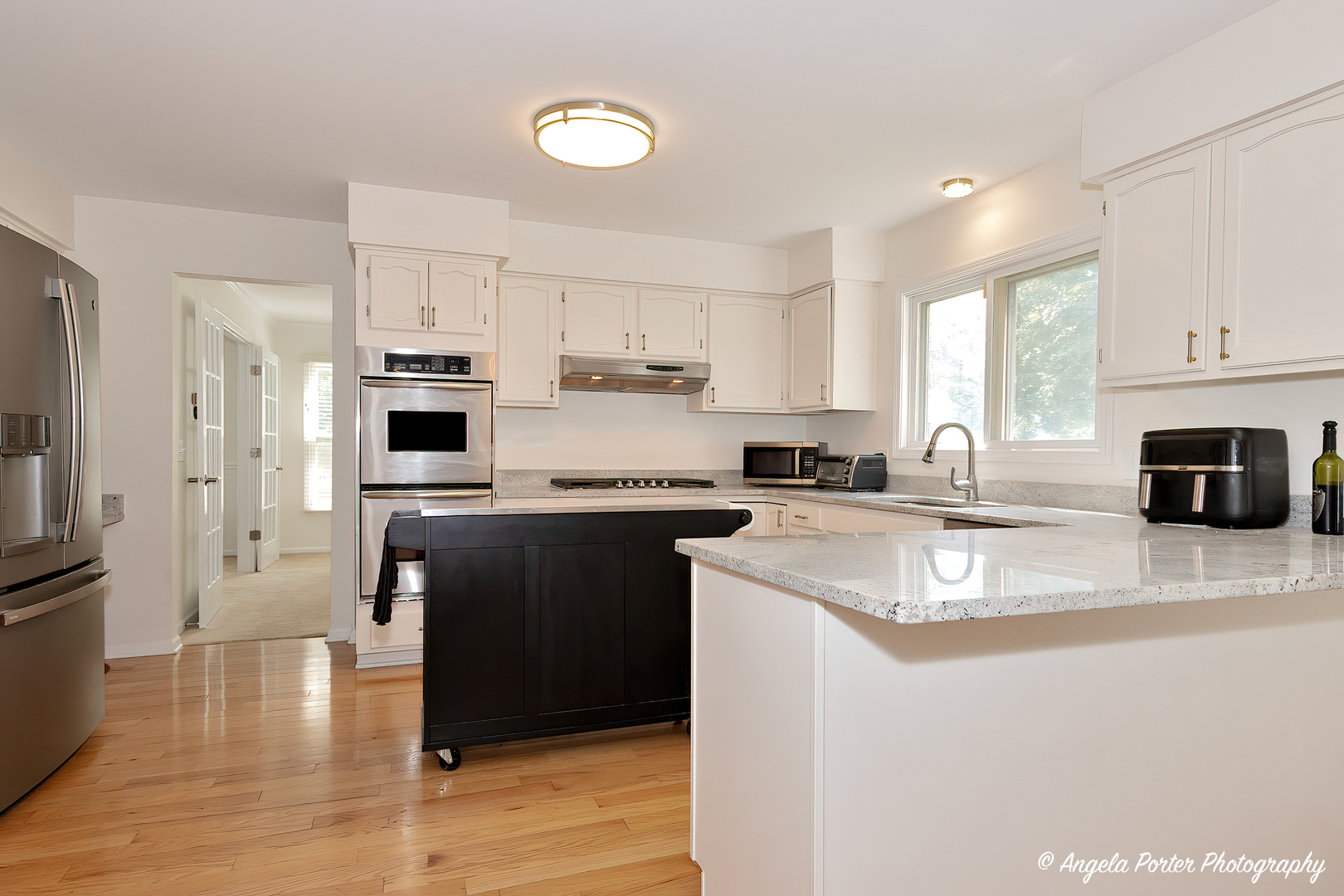 600 Raintree Road Buffalo Grove, IL 60089 - Photo 2 of 46 a kitchen with stainless steel appliances granite countertop a refrigerator a stove sink and white cabinets