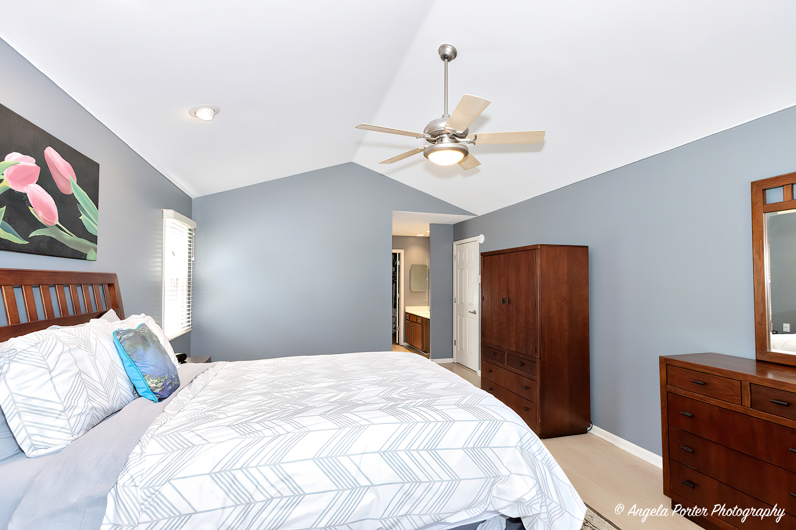 600 Raintree Road Buffalo Grove, IL 60089 - Photo 25 of 46 a bedroom with a bed and a chandelier