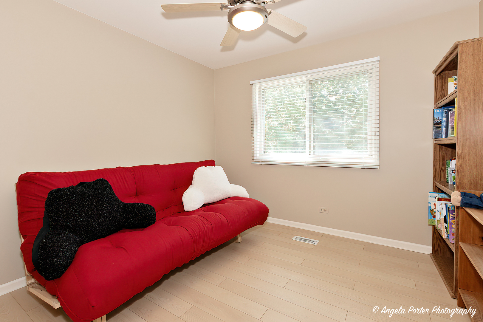 600 Raintree Road Buffalo Grove, IL 60089 - Photo 32 of 46 a living room with a couch and a bookshelf