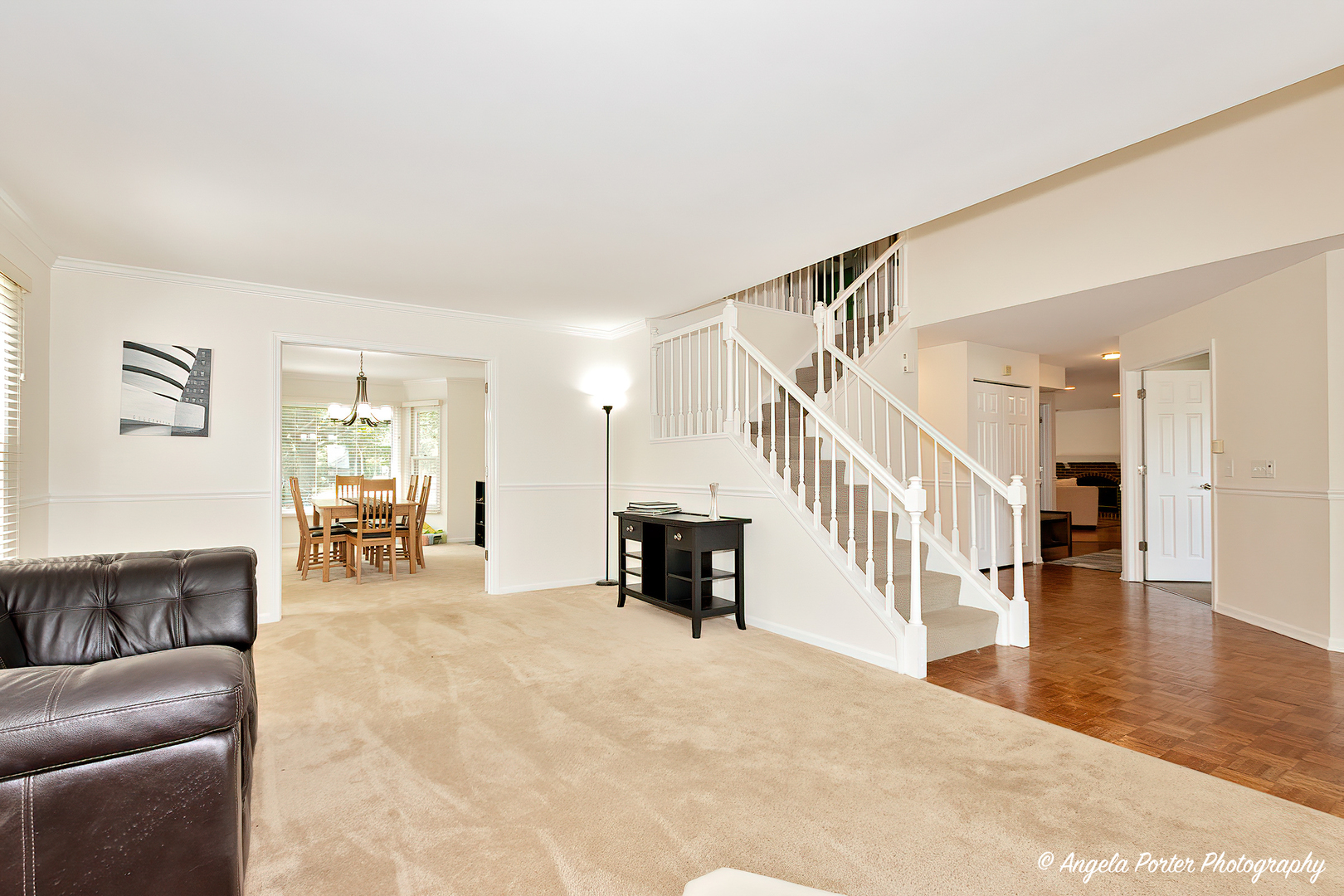 600 Raintree Road Buffalo Grove, IL 60089 - Photo 10 of 46 a living room with furniture and a dining table with wooden floor