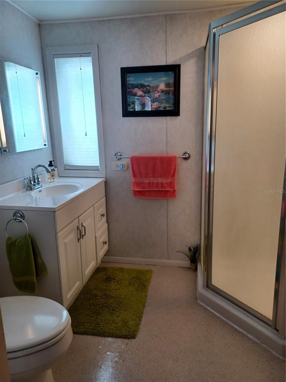 34701 Rosebud Row Zephyrhills, FL 33541 - Photo 6 of 12 a bathroom with a toilet sink and mirror