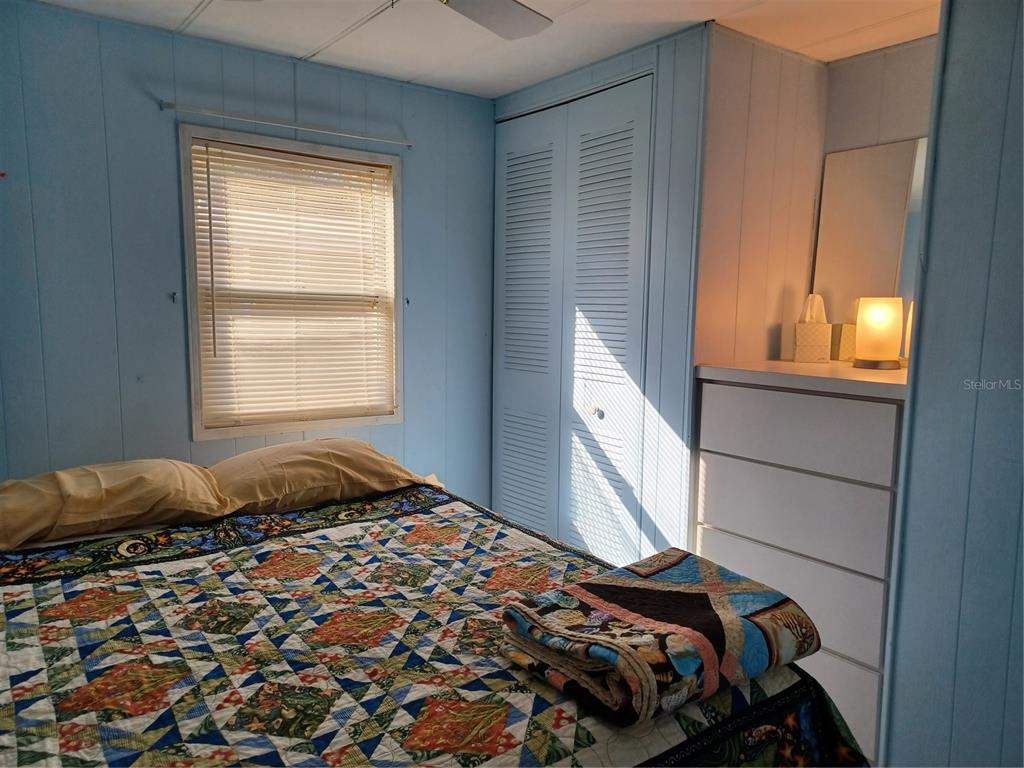 34701 Rosebud Row Zephyrhills, FL 33541 - Photo 7 of 12 a bedroom with a bed and a window