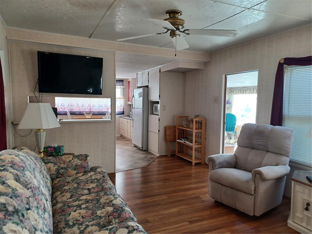 34701 Rosebud Row Zephyrhills, FL 33541 - Photo 8 of 12 a living room with furniture and a flat screen tv