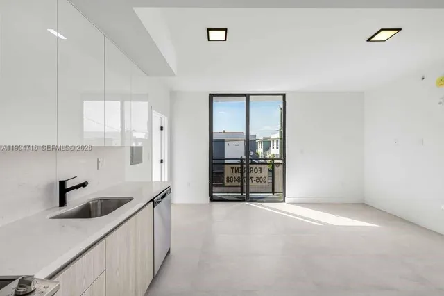 a kitchen with a stove a refrigerator and a sink
