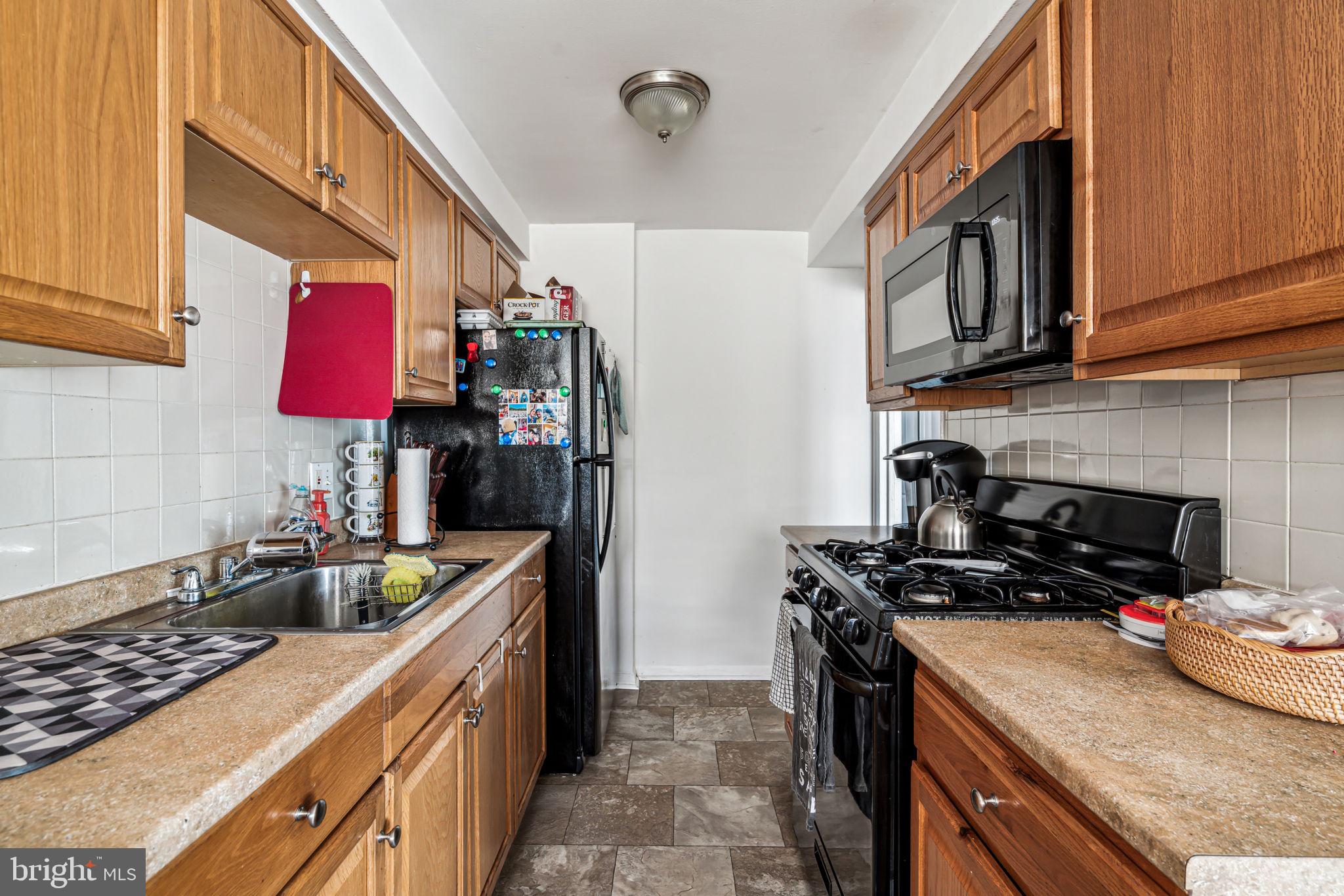 10203 East Keswick Road Philadelphia, PA 19114 - Photo 26 of 36 a kitchen with stainless steel appliances granite countertop a stove a sink and dishwasher