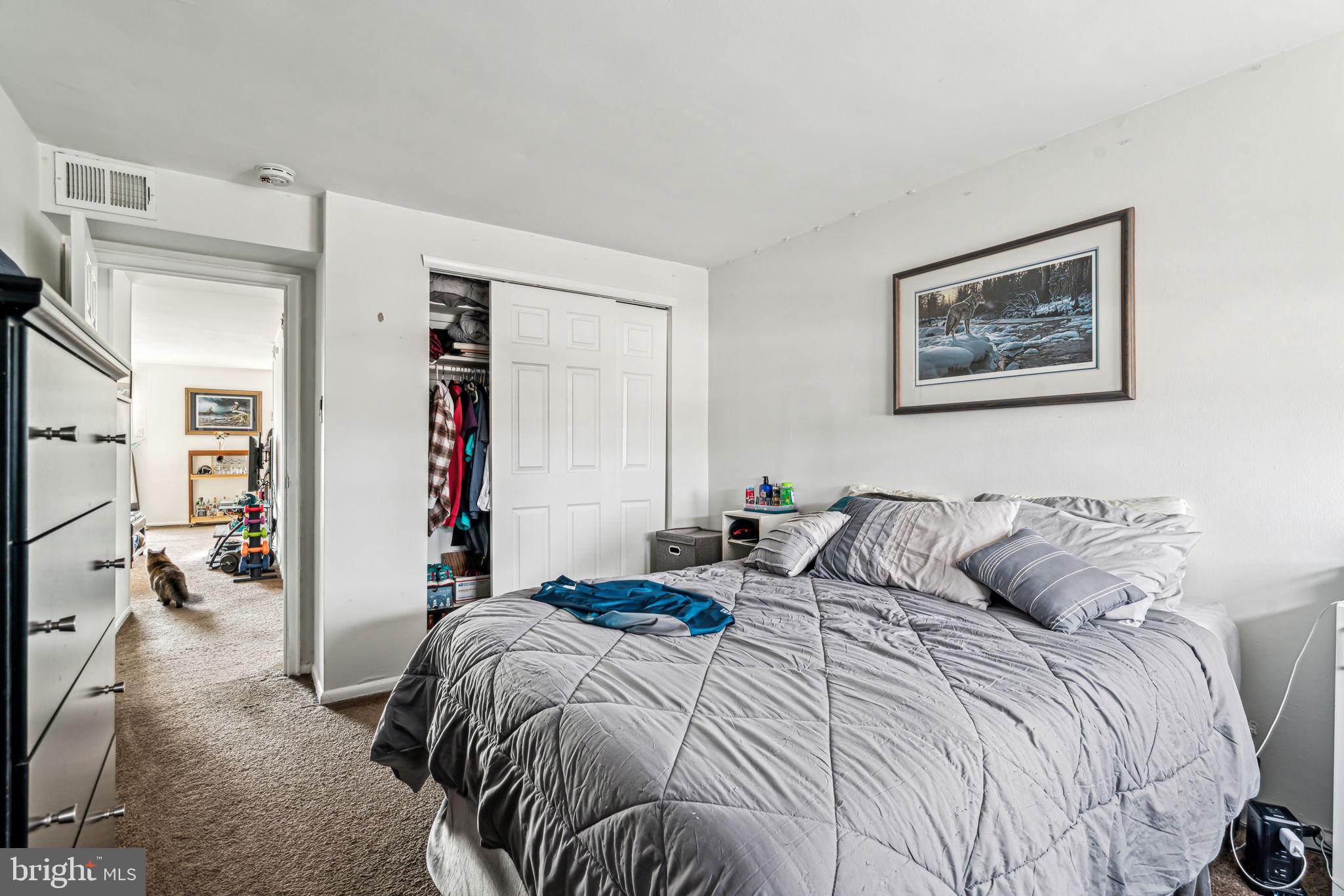 10203 East Keswick Road Philadelphia, PA 19114 - Photo 31 of 36 a bedroom with a bed and a painting on the wall