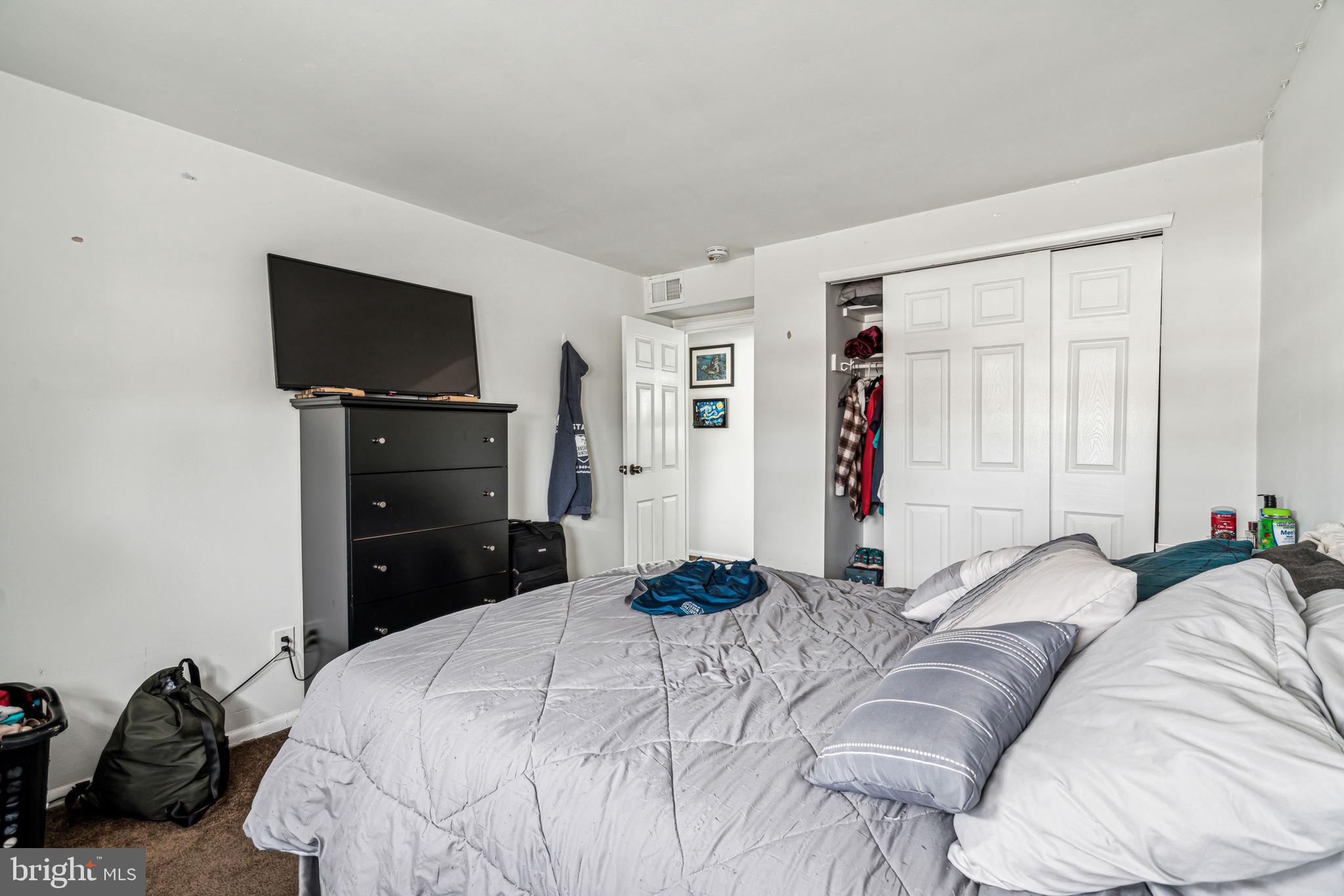 10203 East Keswick Road Philadelphia, PA 19114 - Photo 32 of 36 a bedroom with a bed and a flat screen tv