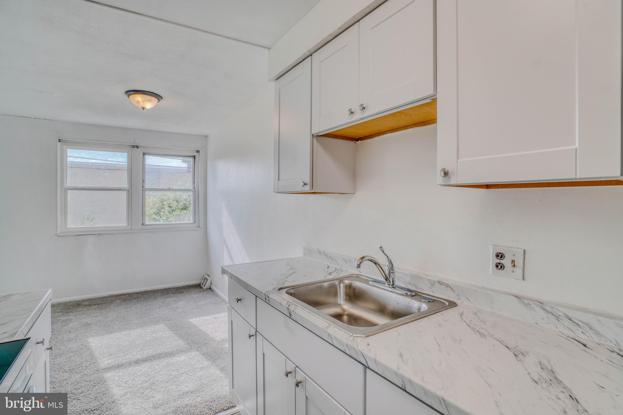 10203 East Keswick Road Philadelphia, PA 19114 - Photo 8 of 36 a kitchen with a sink and cabinets