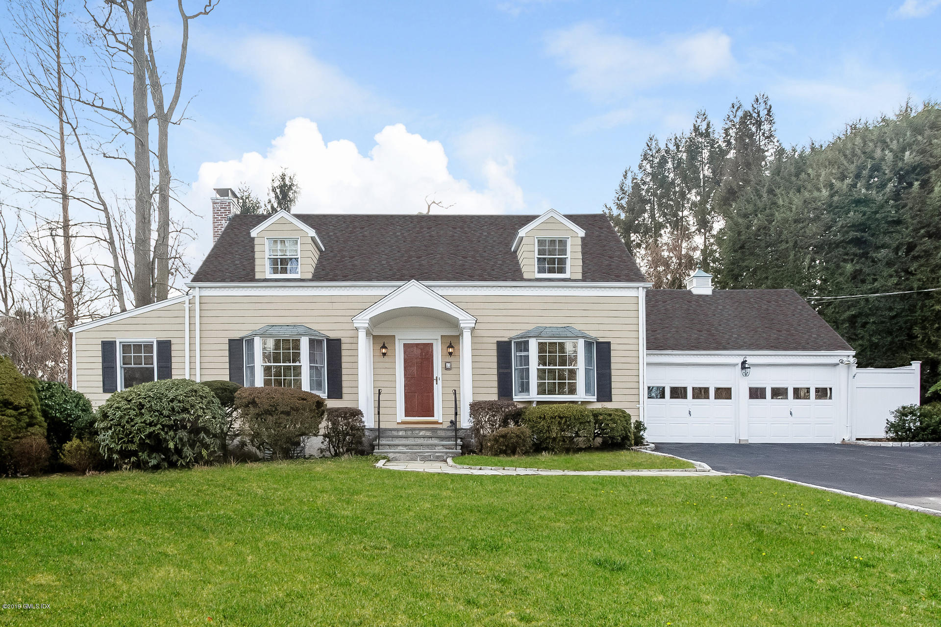 83 Winthrop Drive Riverside, CT 06878 - Photo 1 of 21 a front view of a house with a garden