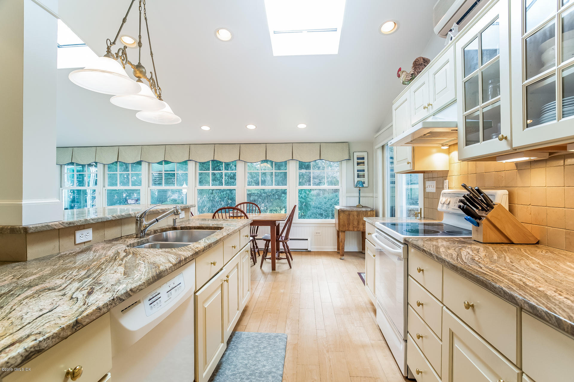 83 Winthrop Drive Riverside, CT 06878 - Photo 8 of 21 a open kitchen with granite countertop a sink a counter top space and living room area