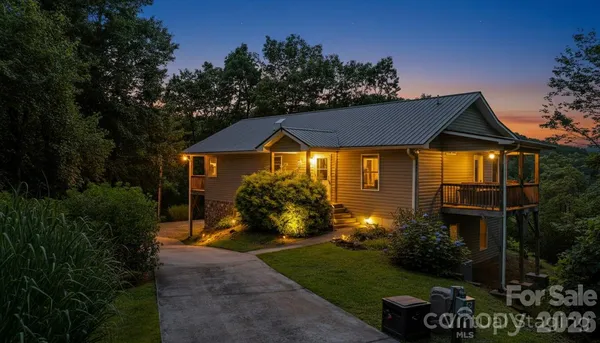 a front view of a house with a yard and outdoor seating