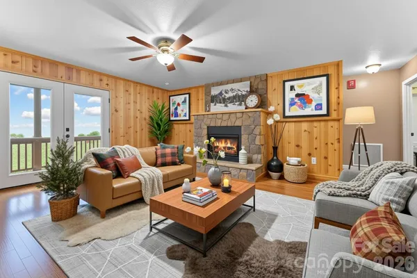 a living room with furniture a chandelier and a fireplace