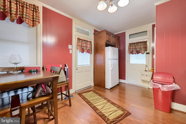 a view of a workspace with furniture and wooden floor