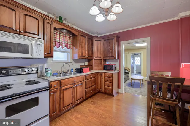 a kitchen with stainless steel appliances granite countertop a stove cabinets and wooden floor