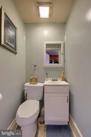 a bathroom with a toilet a sink and a mirror