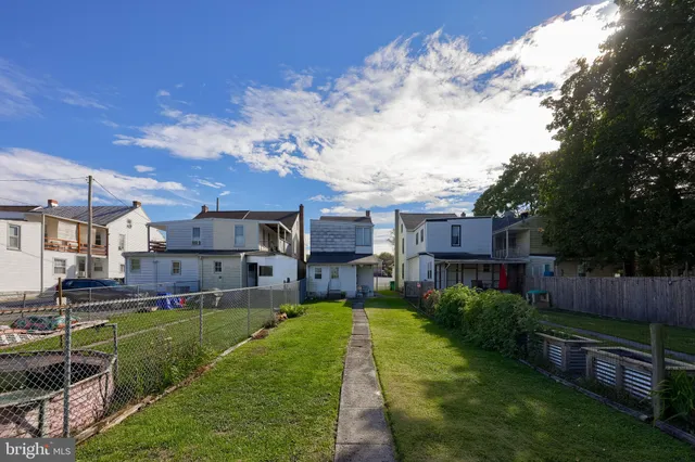 a view of a house with a big yard and a large tree