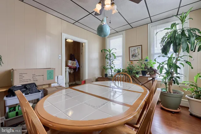 a dining room with a large window table and chairs