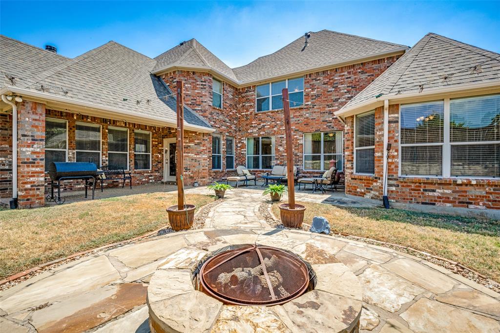 205 Thistle Ridge Denton, TX 76210 - Photo 35 of 40 Backyard with custom firepit