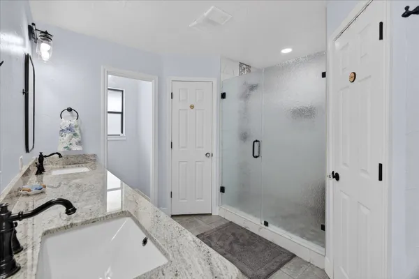 a bathroom with a tub sink and mirror