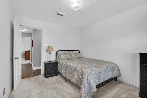 a bedroom with a bed and a mirror