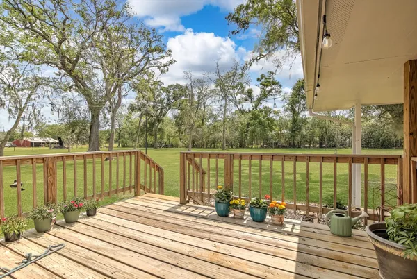 a view of a balcony with lake view and wooden floor