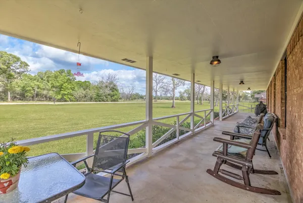 a view of a chair and tables in the balcony