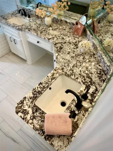 a bathroom with a tub a mirror and shower