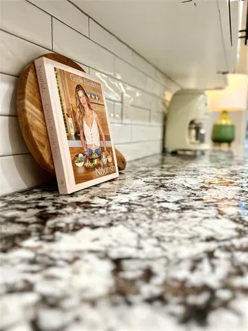 a kitchen with stainless steel appliances a stove microwave and sink