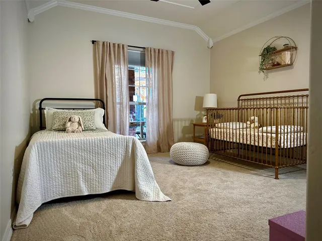 a bedroom with a bed painting and a large window