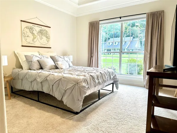 a view of a bedroom with a bed and balcony